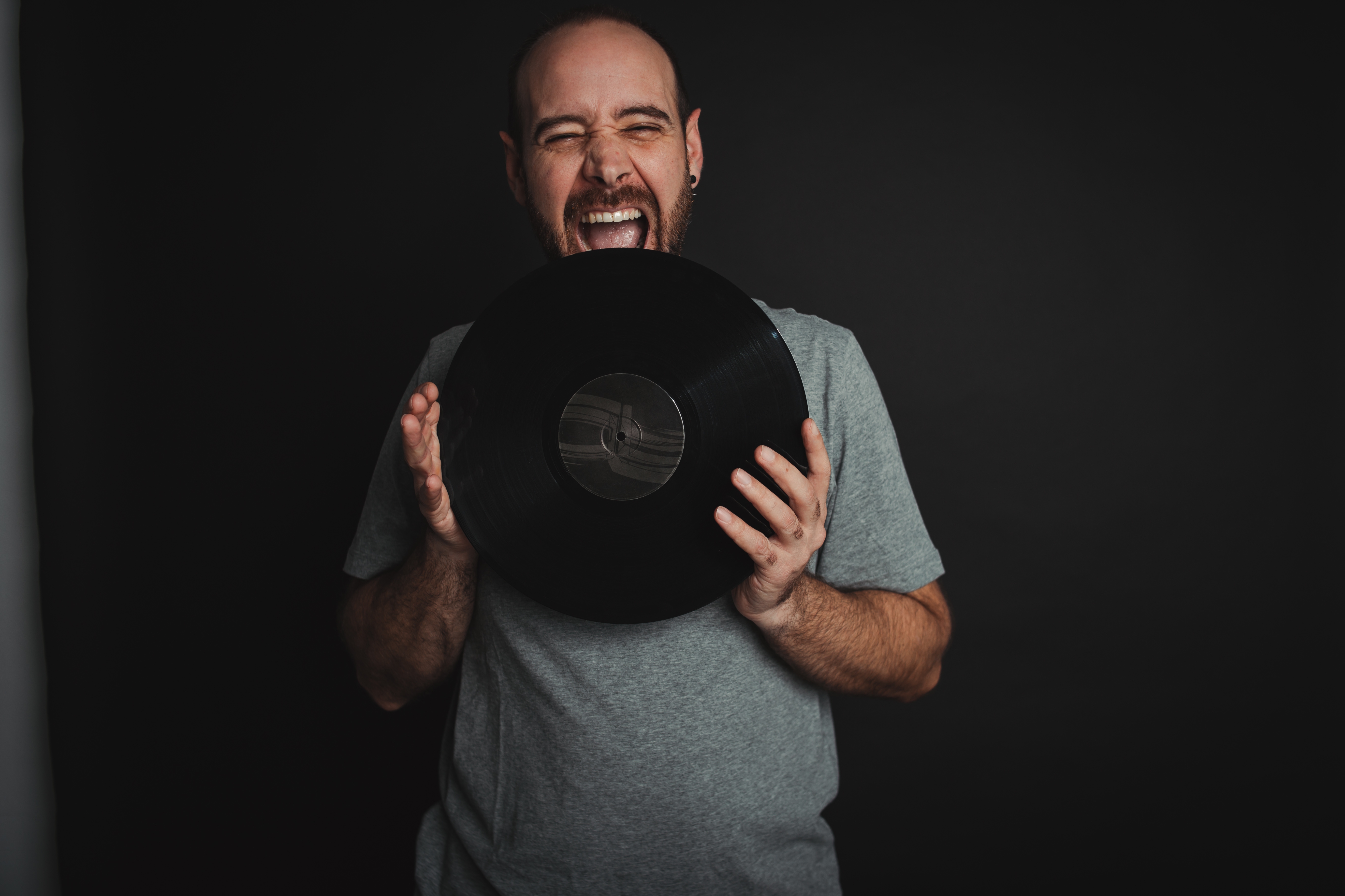 Ashwin, techno DJ, holding a vinyl record
