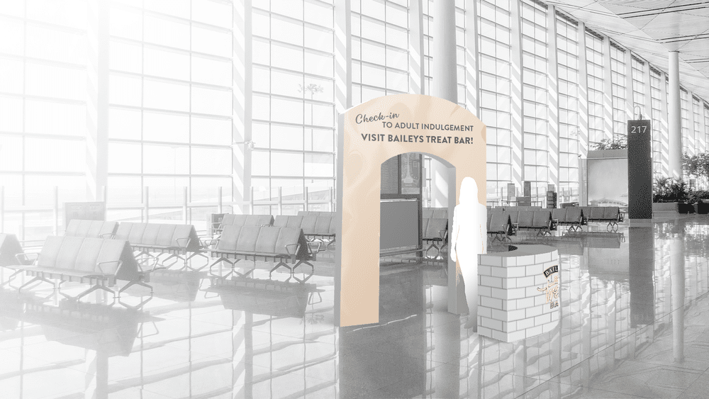 A Baileys Treat Bar branded archway at an airport entrance gate