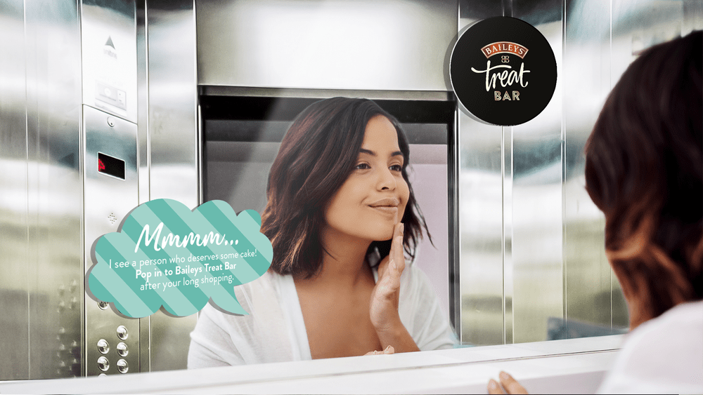 A Baileys Treat Bar mirror sticker placed in a lift
