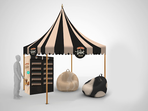 A striped Baileys Treat Bar pop-up canopy with branded vending and beanbags